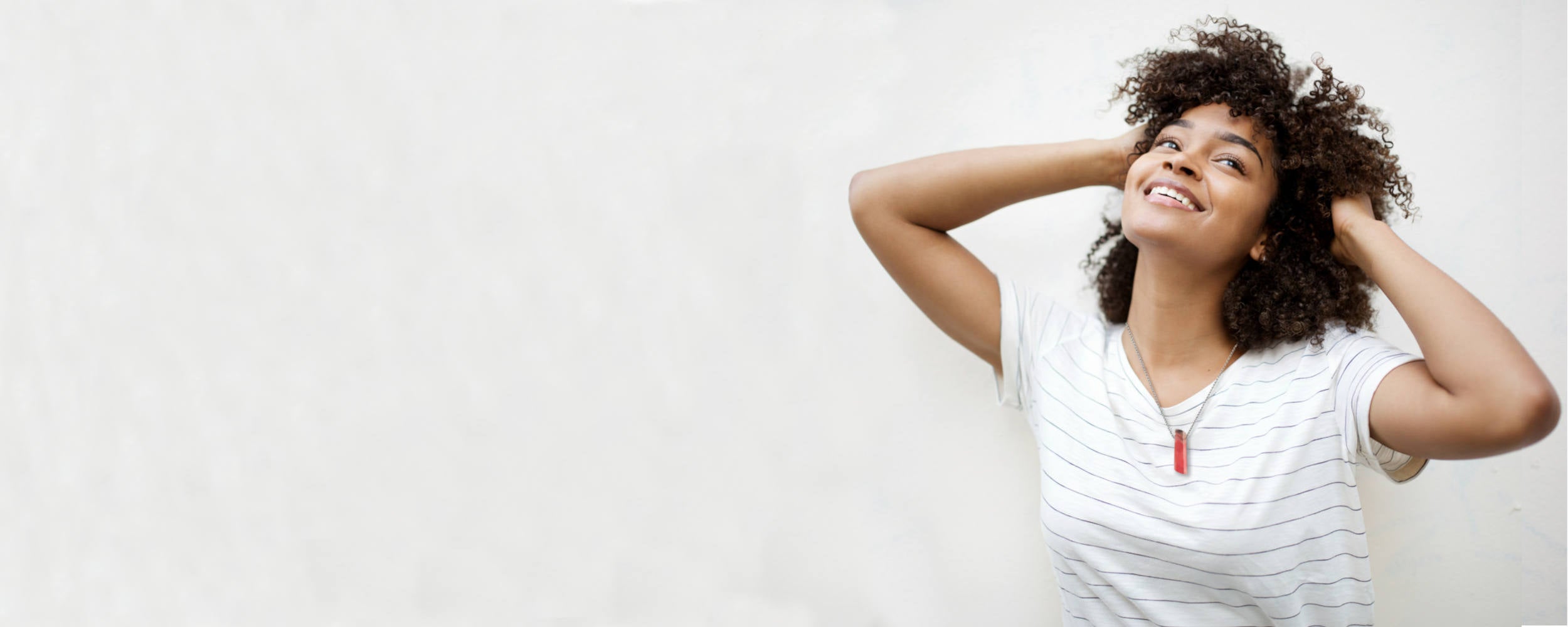 happy young lady wearing a gemstone pendant necklace