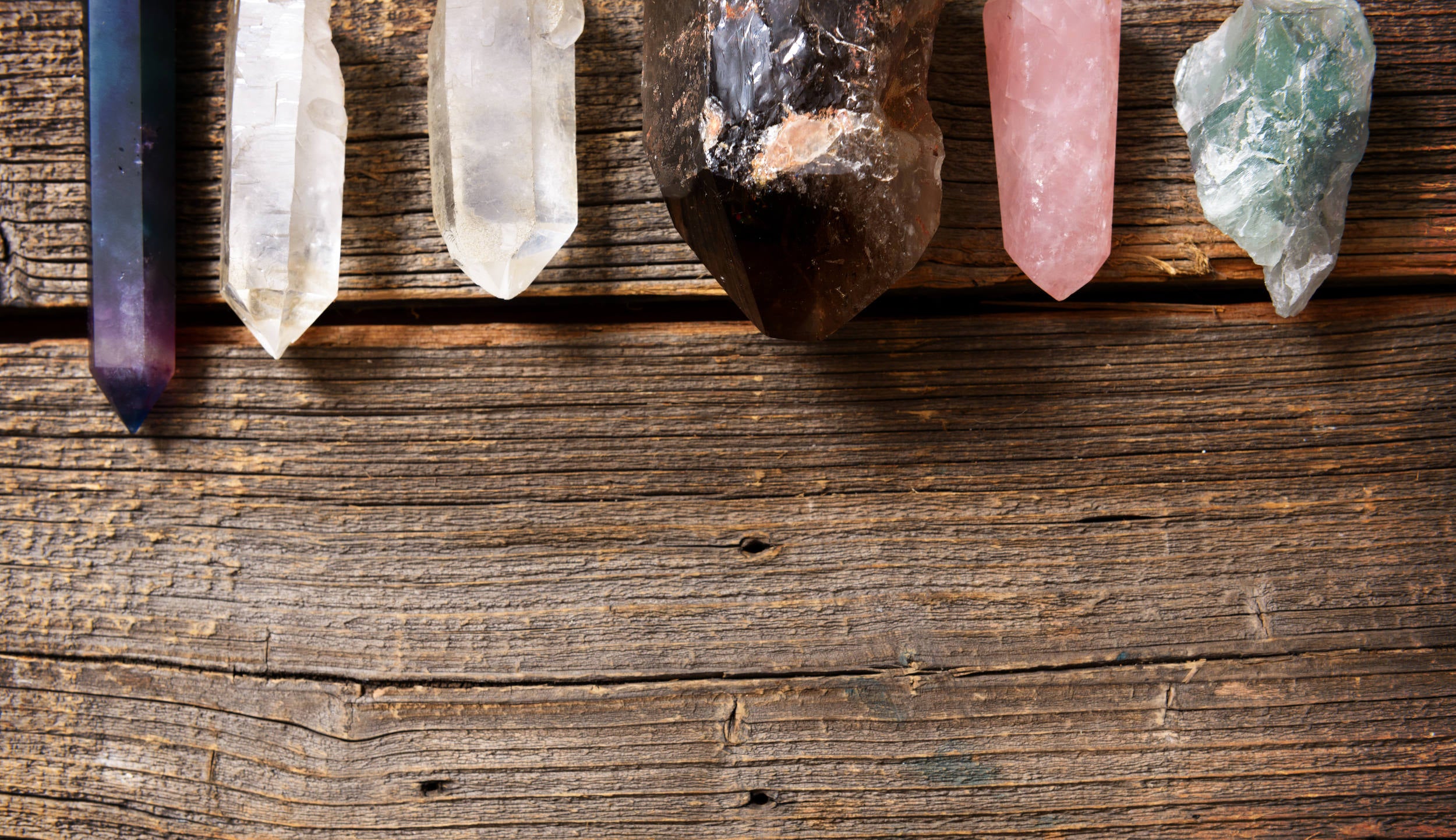 pieces of quarts crystal laying on wood planks