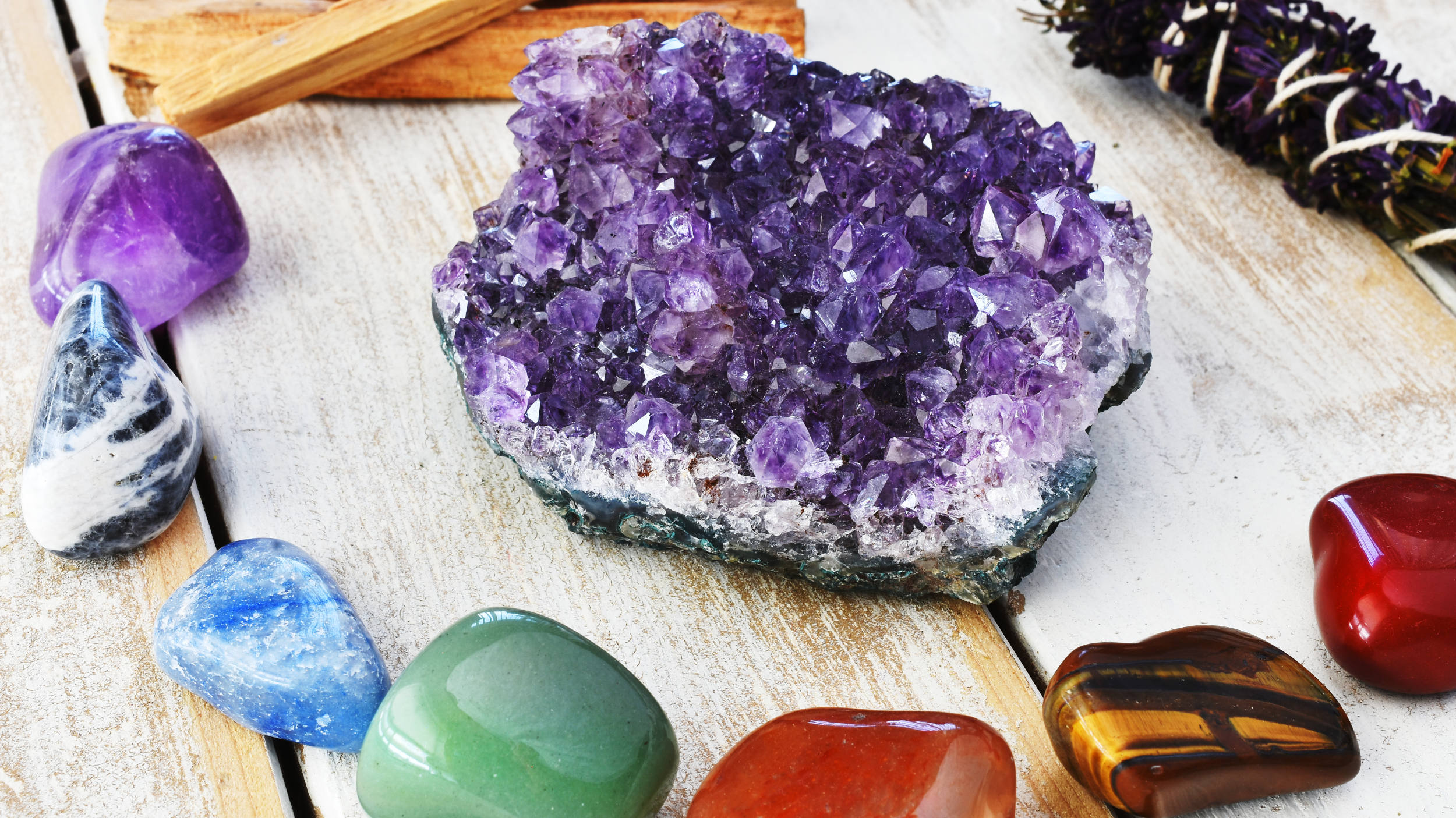 Collection of colorful crystals on a wooden surface