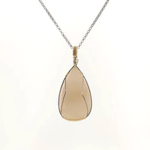 Necklace with a teardrop-shaped drusy agate pendant set in a sterling silver and Gold Filled Wire wrap and bail, on a white background (back view)