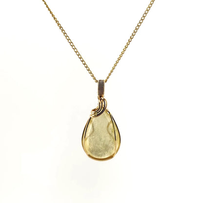 Necklace with a teardrop-shaped Golden Mica pendant showcasing shimmering golden layers that reflect light, with 14K Gold Filled Wire wrapped and bail, on a white background (front view)