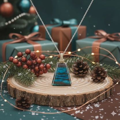 Necklace with a wire-wrapped chrysocolla pendant on a wooden stand with Christmas decorations