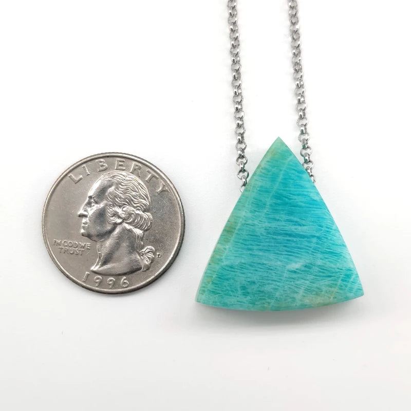 Amazonite pendant necklace next to a quarter on a white background