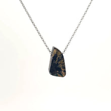 Necklace with a Rutilated Quartz pendant showcasing golden needle-like inclusions within clear quartz, on a white background (front view)