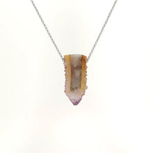 Necklace with a cactus quartz crystal on a white background (back view)