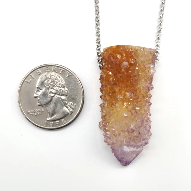 Cactus quartz pendant necklace with a quarter for scale on a white background