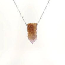 Necklace with a cactus quartz crystal on a white background (front view)