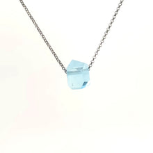 Necklace with a blue topaz pendant on a white background