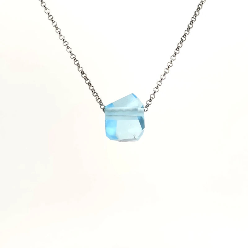 Necklace with a blue topaz pendant on a white background