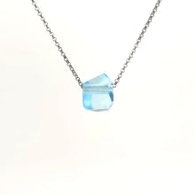 Necklace with a blue topaz pendant on a white background