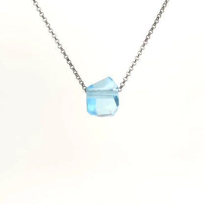 Necklace with a blue topaz pendant on a white background