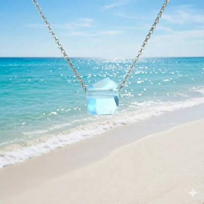 Necklace with a blue topaz pendant with a beach background