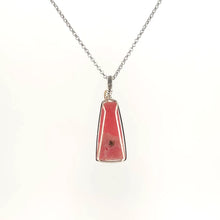 Necklace with Rhodochrosite pendant set in sterling silver wire wrap and bail, on a white background (back view)