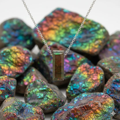 Necklace with a rectangular ammolite pendant on a background of iridescent stones
