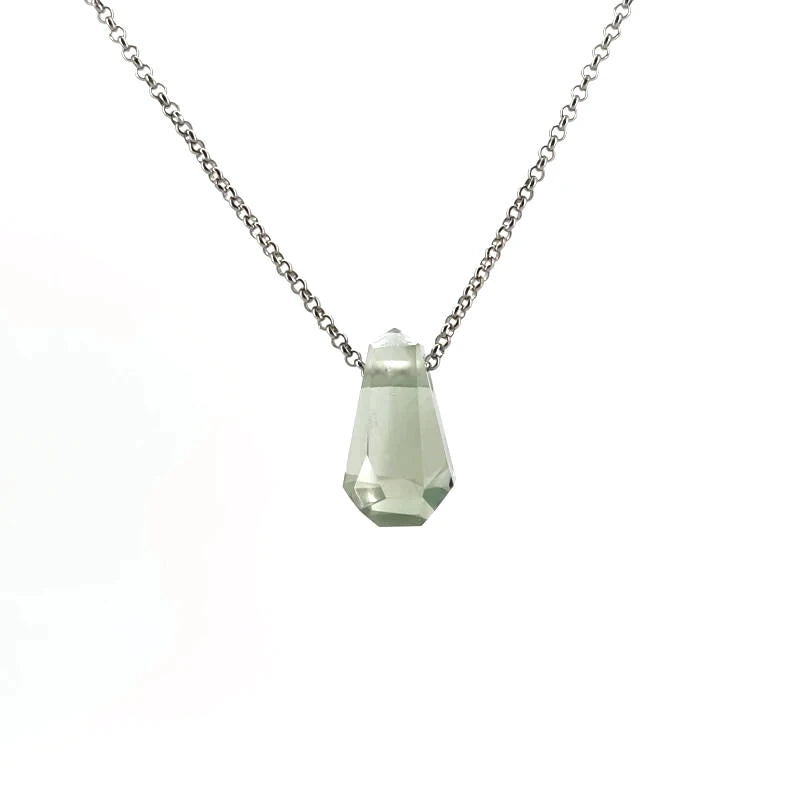 Necklace with a green crystal on a white background
