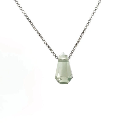 Necklace with a green crystal on a white background