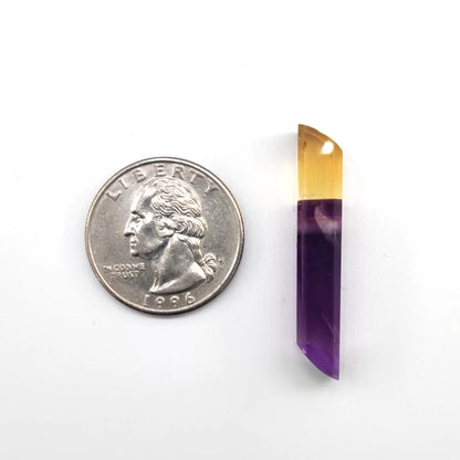 Amethyst and citrine intarsia pendant next to a quarter on a white background