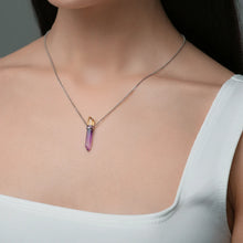 Close-up of a woman wearing the neckless with amethyst and citrine intarsia