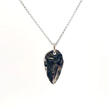 Necklace with a Drusy Pyritized Ammonite pendant combining the ancient spiral form of a fossil with sparkling pyrite crystals on its surface, on a white background (front view)
