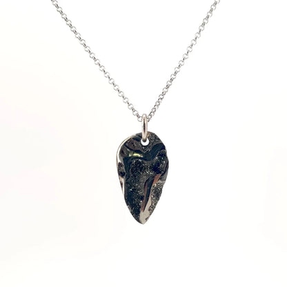 Necklace with a Drusy Pyritized Ammonite pendant combining the ancient spiral form of a fossil with sparkling pyrite crystals on its surface, on a white background (front view)