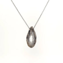 Necklace with a Oco Geode pendant featuring natural crystal-lined interiors within an agate shell, on a white background (back view)