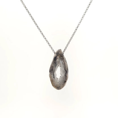 Necklace with a Oco Geode pendant featuring natural crystal-lined interiors within an agate shell, on a white background (back view)
