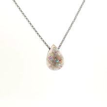Necklace with a teardrop-shaped Angel Aura Treated Drusy pendant sparkles with a shimmering iridescent surface, on a white background (front view)