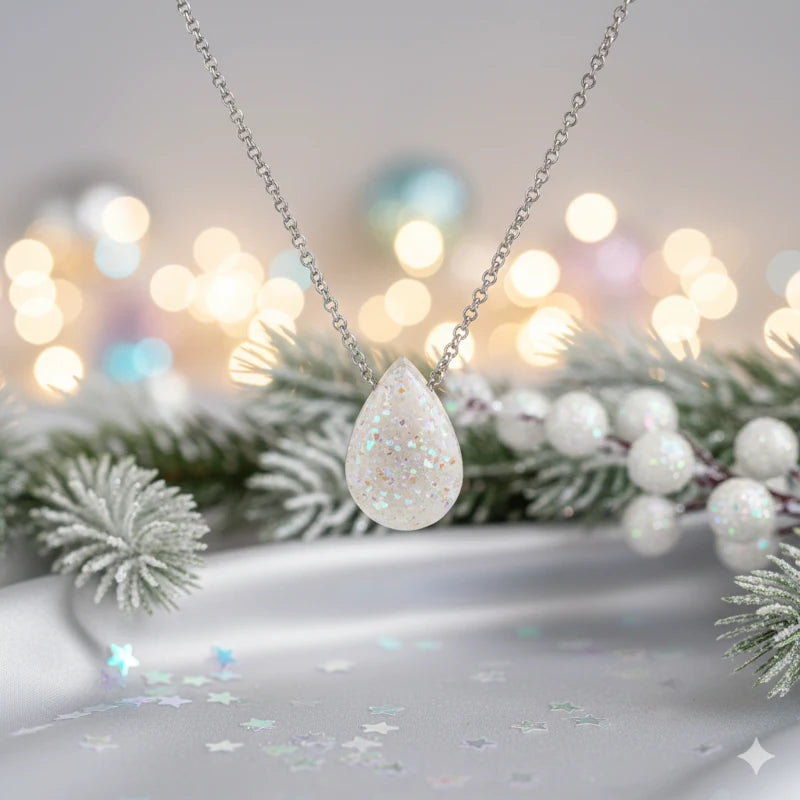 Necklace with a teardrop-shaped pendant on a blurred festive background