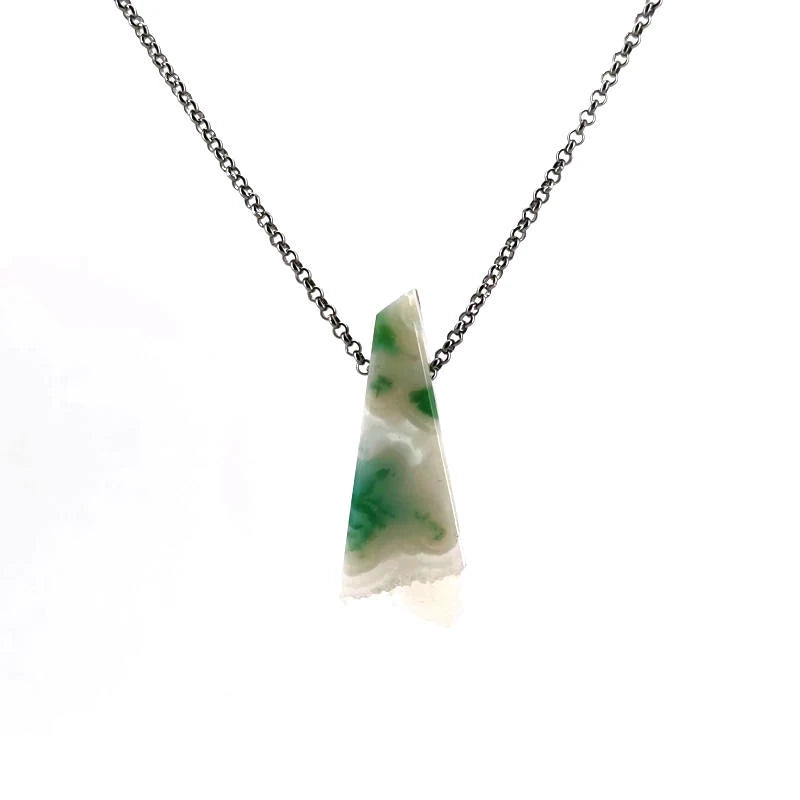 Necklace with a white agate pendant on a chain against a white background