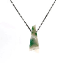 Necklace with a white agate pendant on a chain against a white background