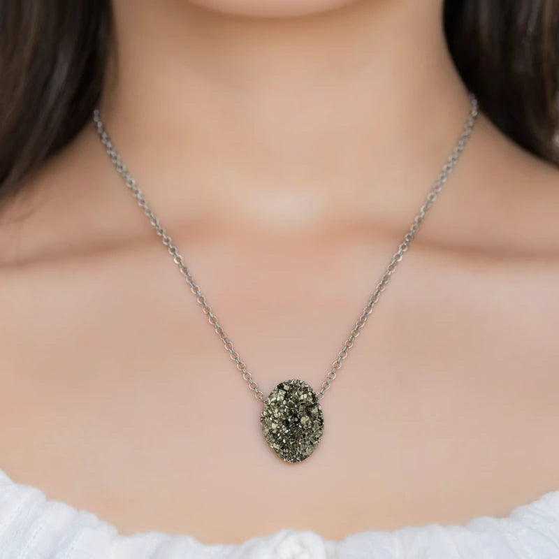Necklace with a pyrite pendant worn by a person