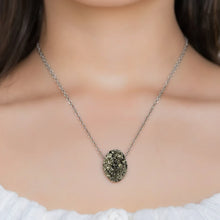 Necklace with a pyrite pendant worn by a person