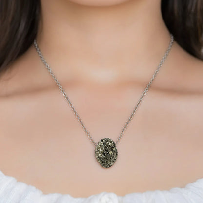 Necklace with a pyrite pendant worn by a person