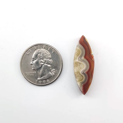 Natural stone next to a U.S. quarter on a white background