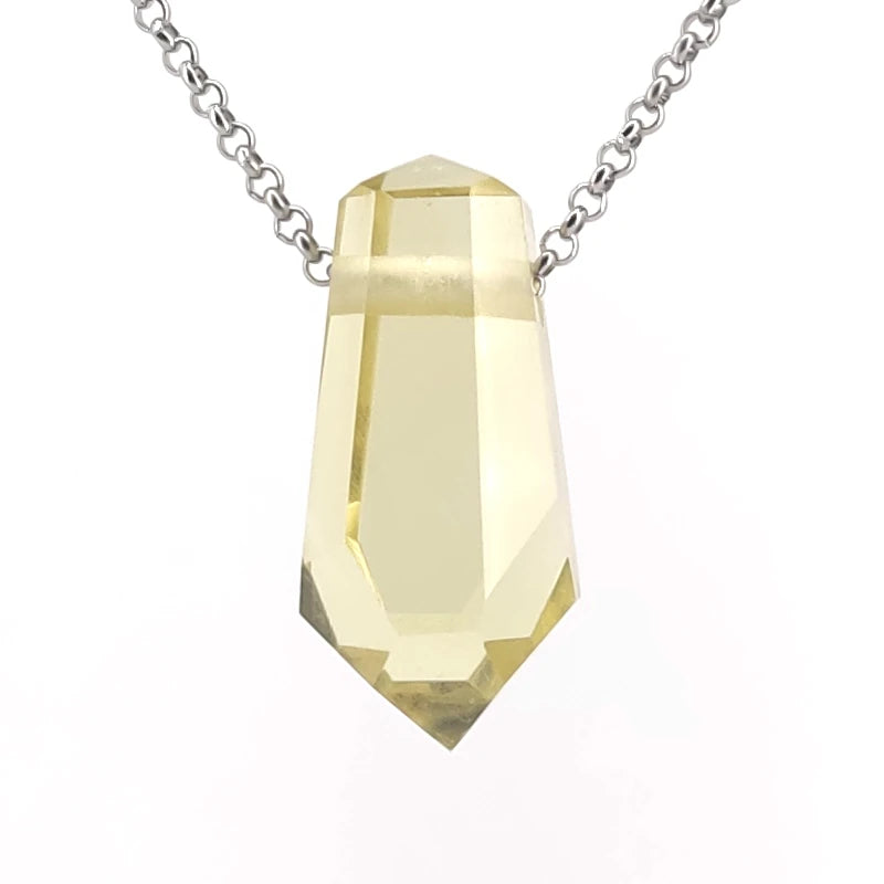 Lemon quartz pendant on a chain against a white background