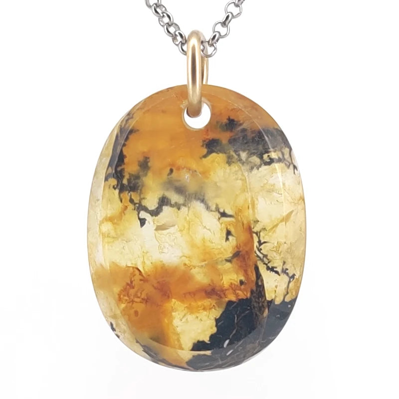 Oval-shaped quartz pendant on a white background