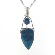Apatite and blue topaz pendant necklace on a white background