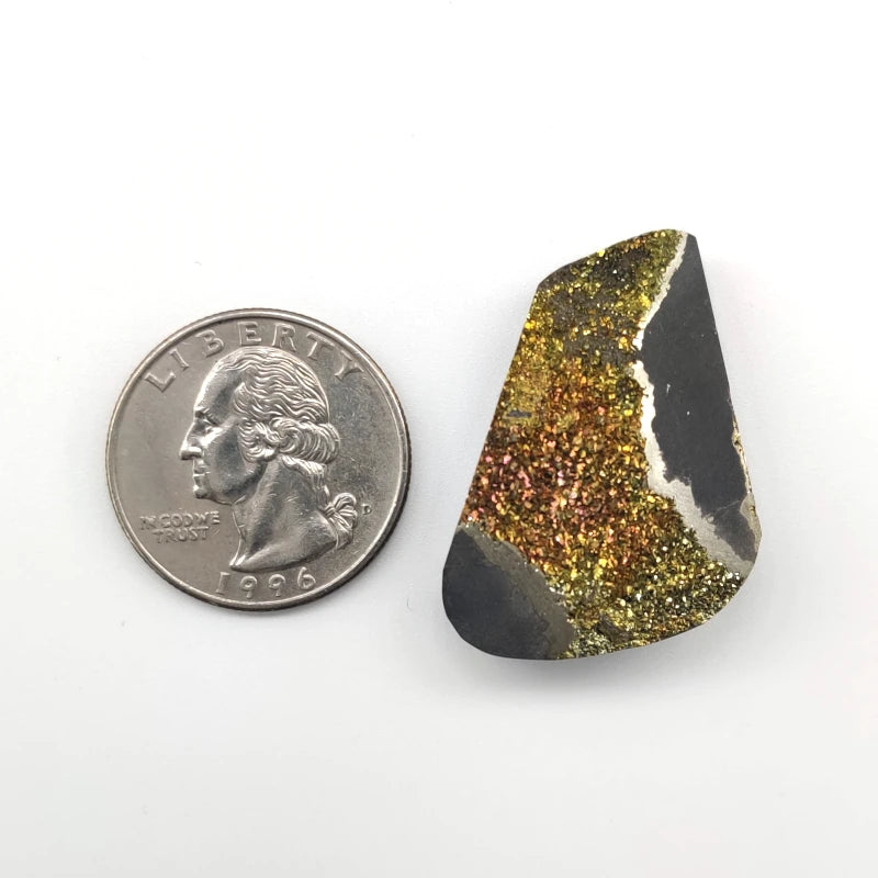 Natural stone next to a U.S. quarter on a white background