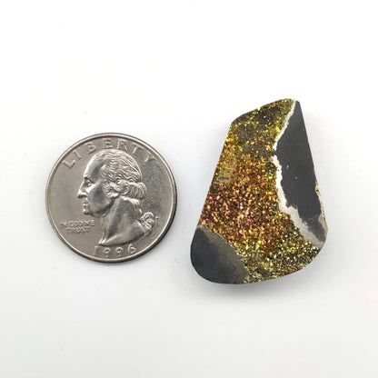 Natural stone next to a U.S. quarter on a white background