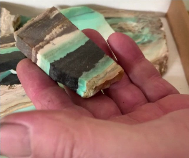 Load video: Short video of worker cutting and polishing a gemstone pendant