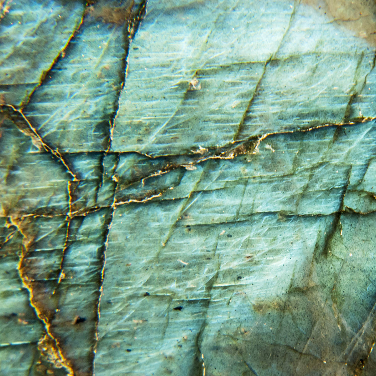 Green colored rock with golden crack lines