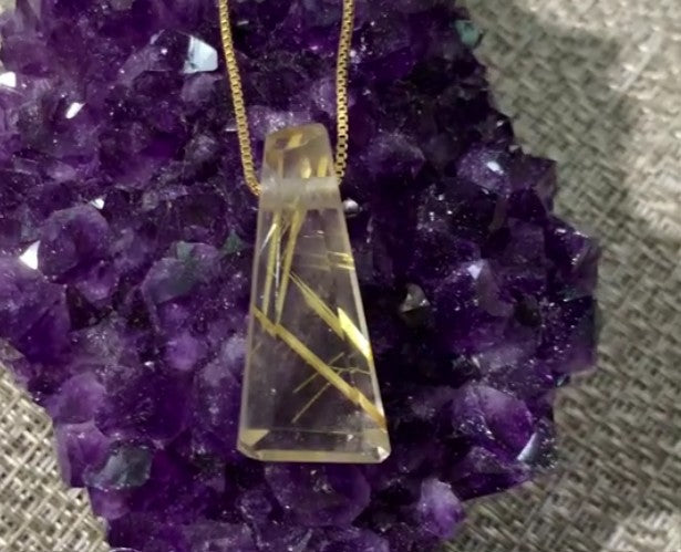 Load video: Short video of a hand working on a cut gemstone